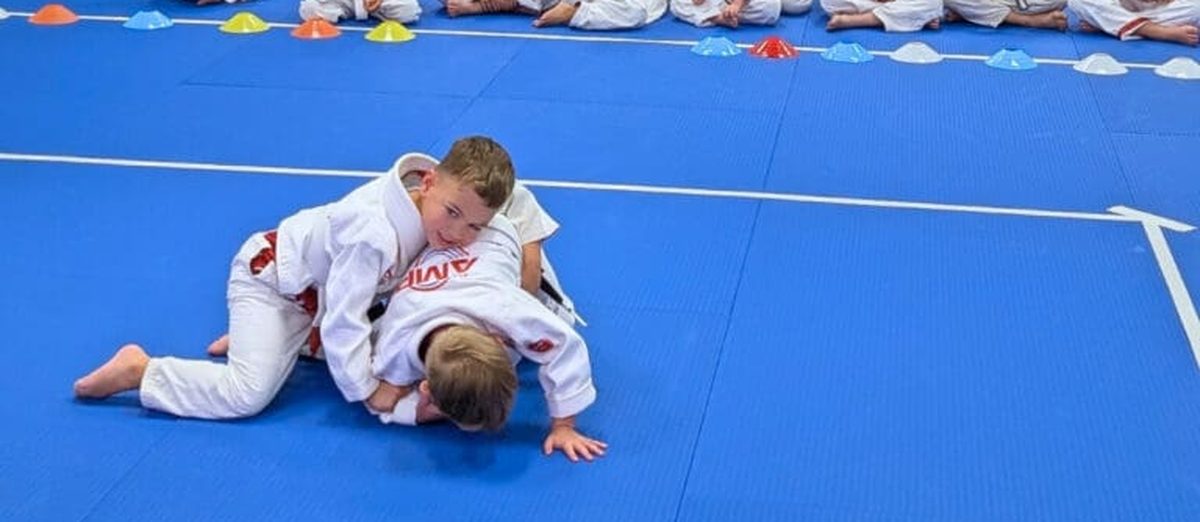 Two kids competing at an AMP in-house tournament